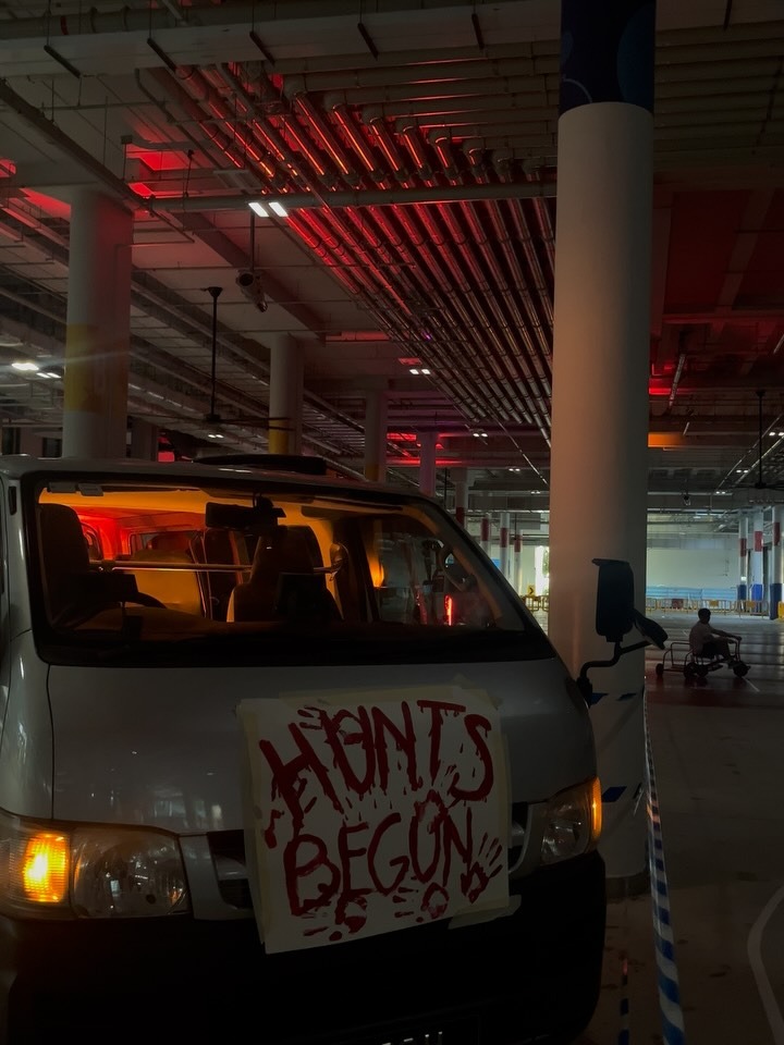 A van with a hand-painted 'Hunts Begun' sign in the campus car park