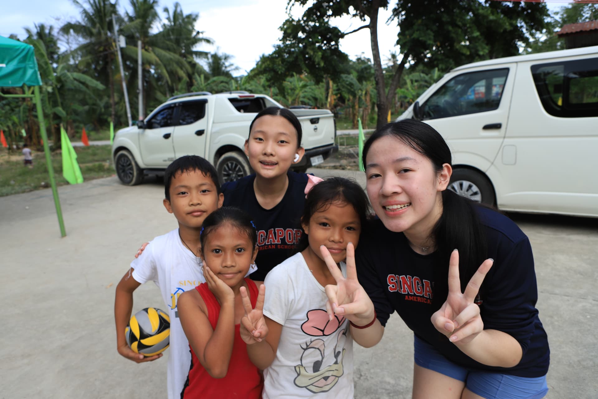 A club member with children in the SAS GK village