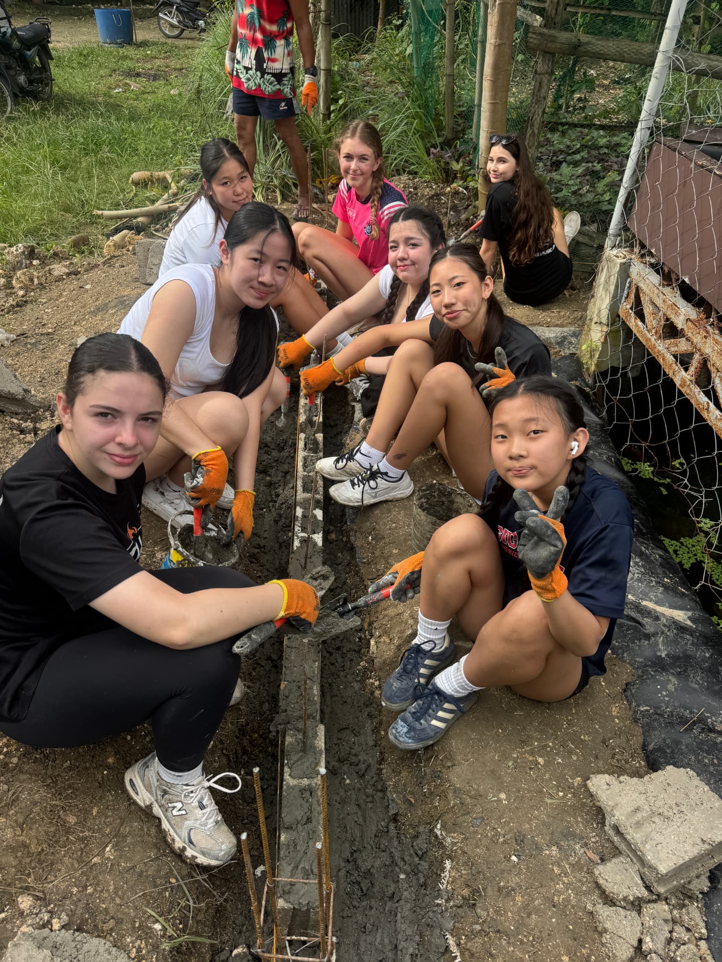 Club members laying cement foundations at the SAS GK village