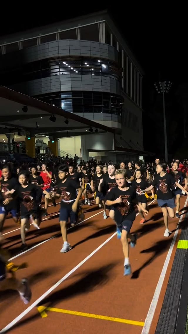 Students running the SAS Gawad Kalinga Zombie Run on campus at night