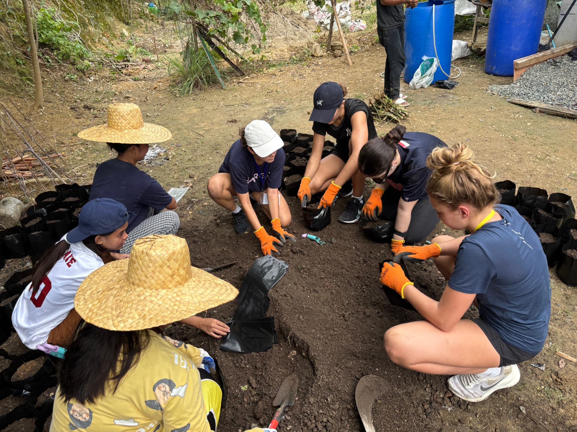 Club members potting seedlings at the SAS GK village