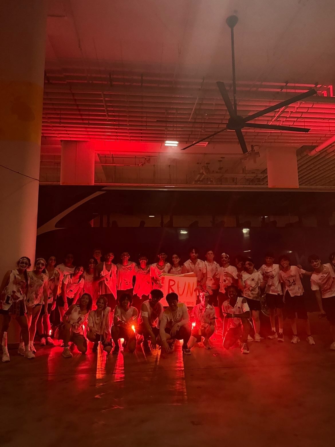 Student zombies posing under red lights before the race